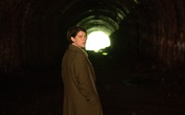 Jessie Buckley looks over her shoulder in a tunnel in the movie "Men."