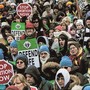 Picture of a march crowded with people holding signs that read"stop abortion now" and "defend life."