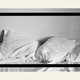An image of rumpled white pillows on top of a bed