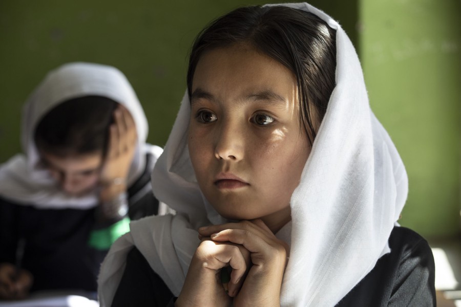 A student sits in a classroom, listening.