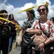 A woman shows writing reading 'my uterus is a ZAD (zone to defend)' as protesters face supporters of the anti-gay marriage La Manif Pour Tous (Protest for Everyone) movement during a protest against medically assisted procreation techniques for lesbian couples and surrogacy on May 10, 2016 in Nantes, western France. 