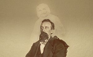A vintage photo of a bearded man with the ghostly image of another person superimposed
