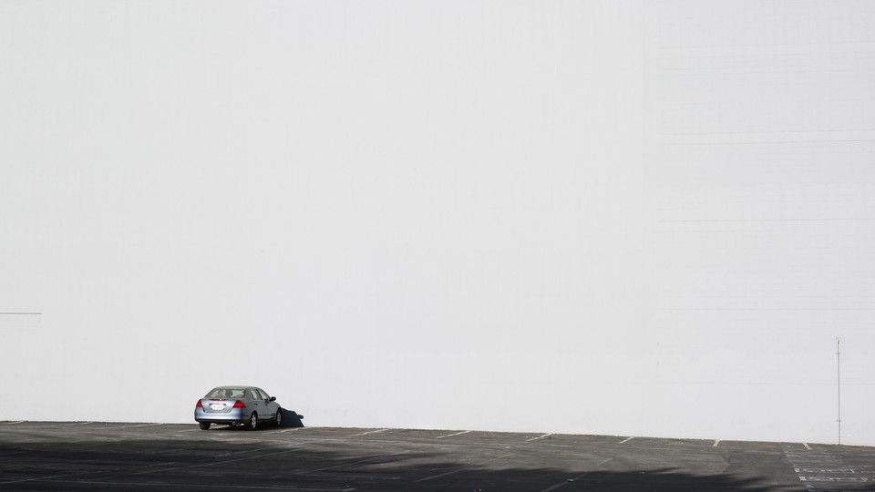 Photo of a lone car in a parking lot