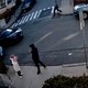 Plainclothes immigration law enforcement officers approach a student in a hijab to detain her