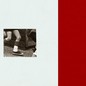 A black and white, grainy image of a child's legs in motion, on a background that's half beige and half red