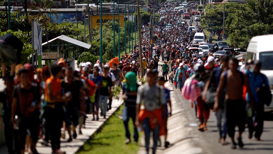 Central American migrants walk along the highway in Tapachula, near Mexico’s border with Guatemala, on October 21 as they continue their journey toward the U.S. border.