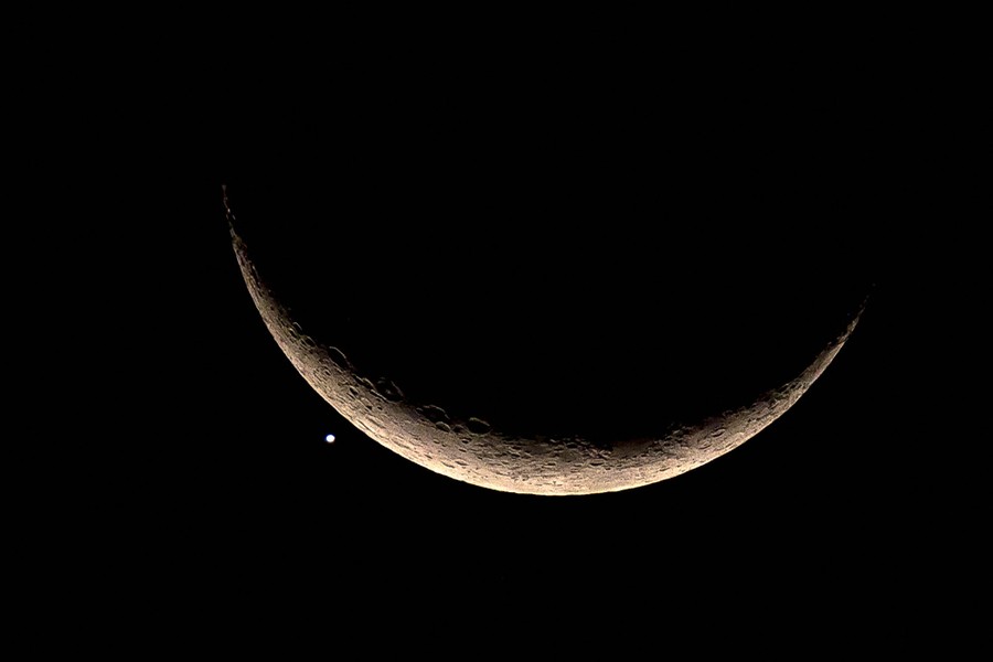 The crescent moon and Venus in the night sky