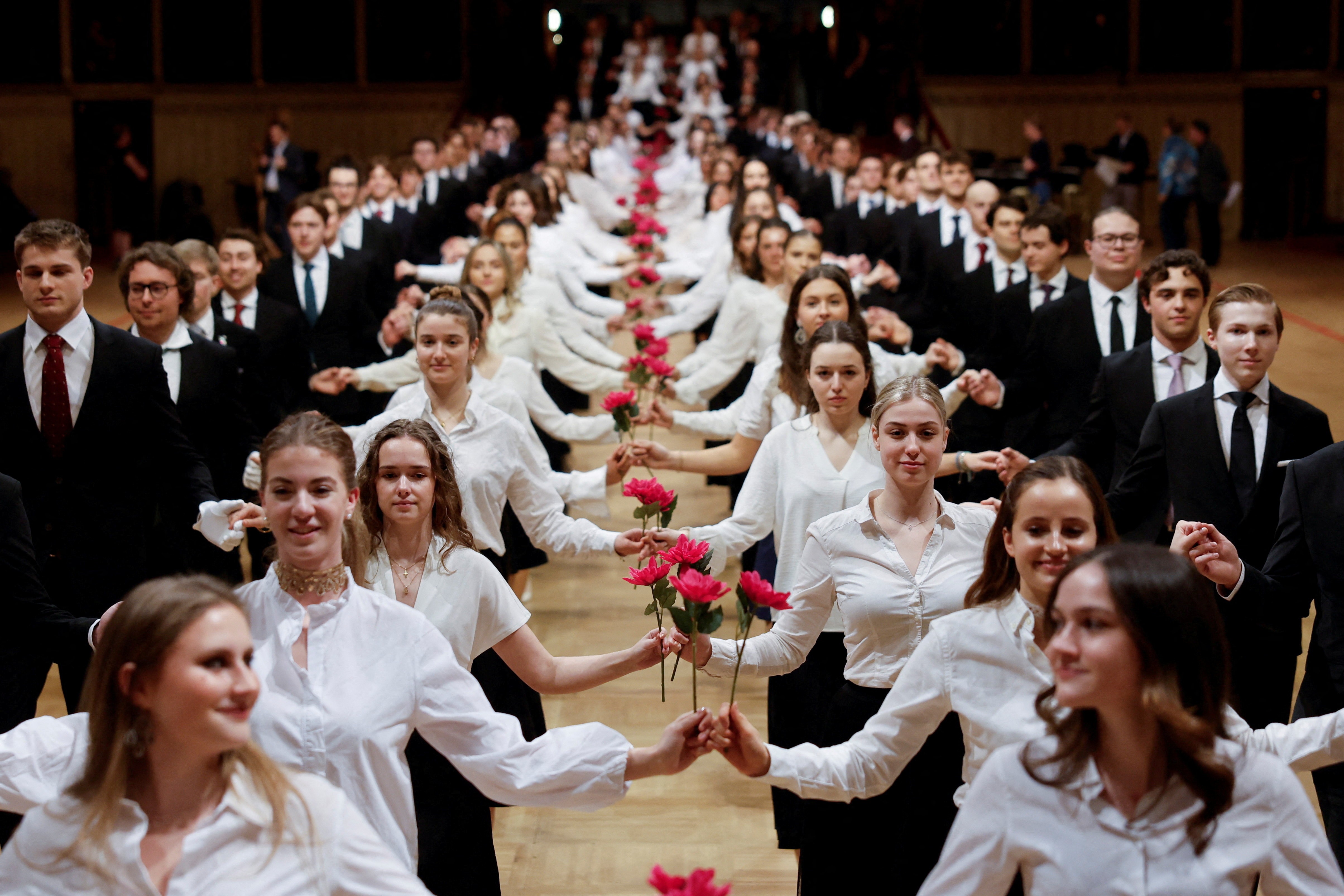 Young men and women perform during a dress rehearsal for a traditional Opera Ball.