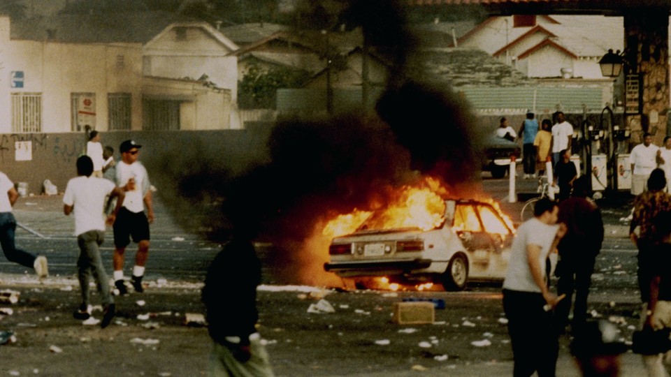 A car burns at the intersection of Florence and Normandie Avenues, which is considered the flashpoint of the L.A. Riots in 1992.