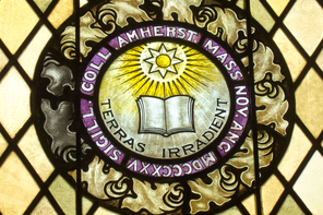 A stained-glass window depicting the Amherst College seal