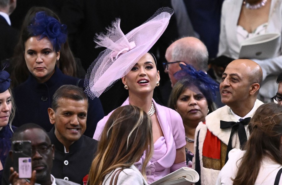 Katy Perry stands among others in an audience.