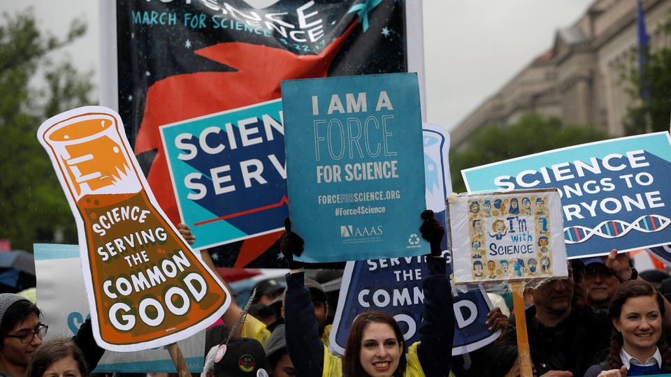 Demonstrators in Washington, D.C., hold signs that promote science