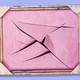 A blank pink canvas with knife slashes through it