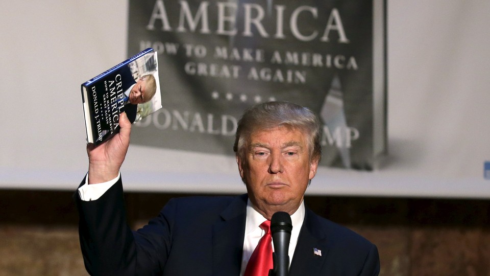 Donald Trump holding up a copy of his book "Crippled America"