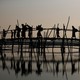 Rohingya refugees cross a bamboo bridge.