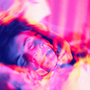A psychedelic, colorful composite of several images of a woman in childbirth overlaid on top of one another