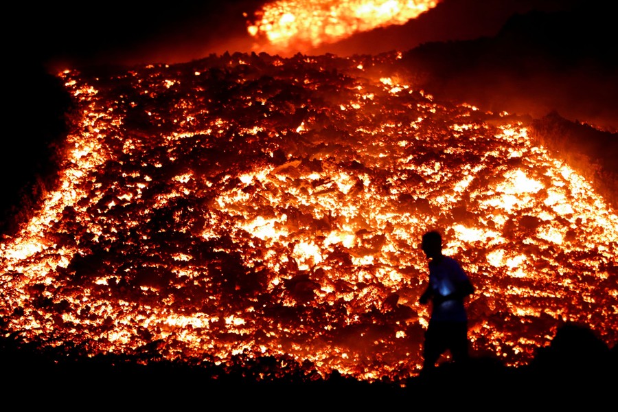 Red-hot lava flows during an eruption.