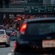 Cars and trucks drive in bumper-to-bumper traffic on a highway in Los Angeles.
