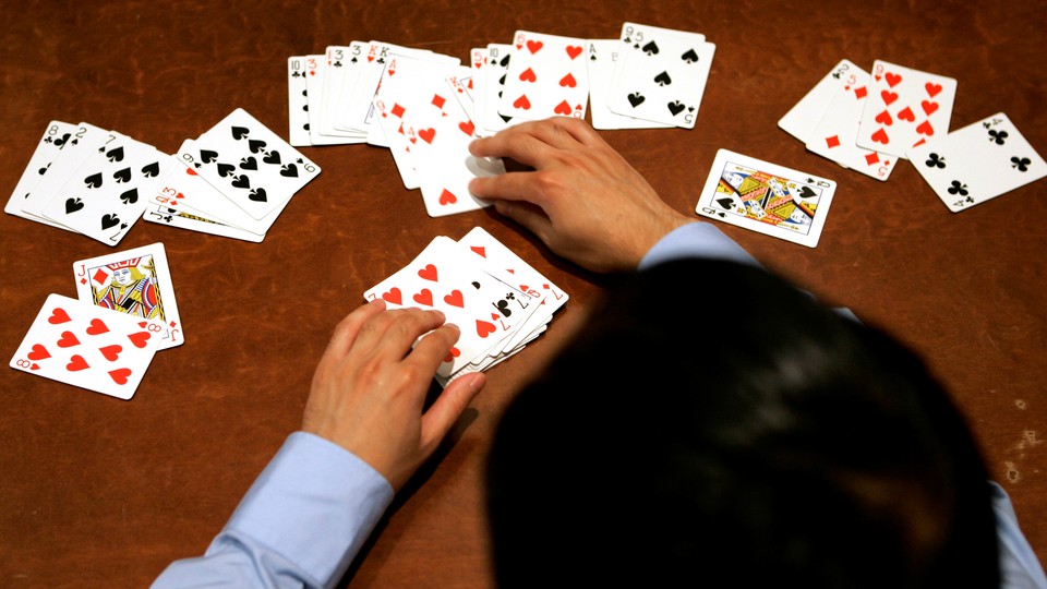 A person sorts a deck of cards.
