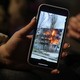 Photo of a Ukrainian refugee's smartphone, showing a video of an apartment block on fire in the city of Mykolaiv