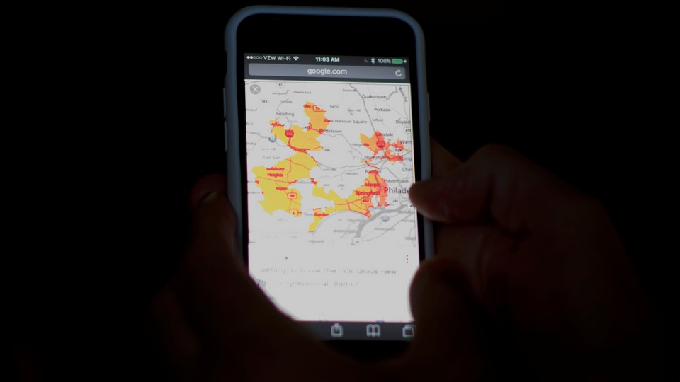 A phone shows a map of Pennsylvania's 17th congressional district