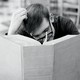 A man reads a very large book
