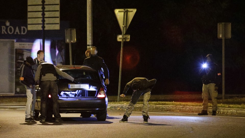 Police inspect a car near a building in Boussy-Saint-Antoine on September 8, 2016.