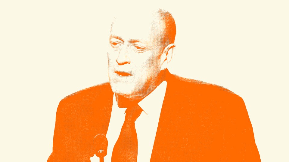 Francis Davis in a suit speaking into a microphone