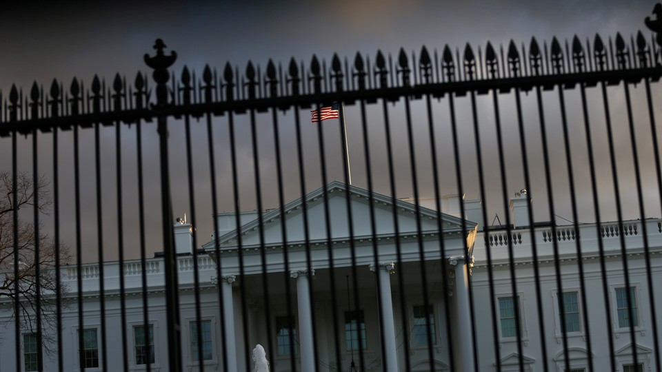 The White House is seen behind a gate.