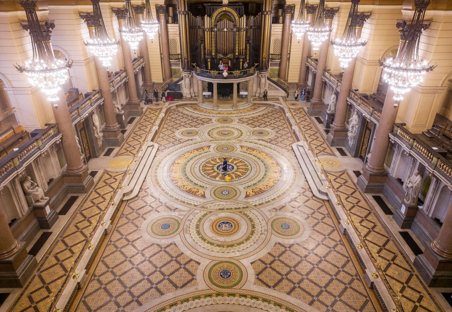 An elevated view of a large open space inside a Victorian-era hall.