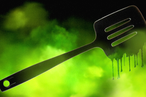 An illustration of a black plastic spatula melting in a neon-green cloud.