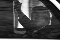 Trump in black and white through car window