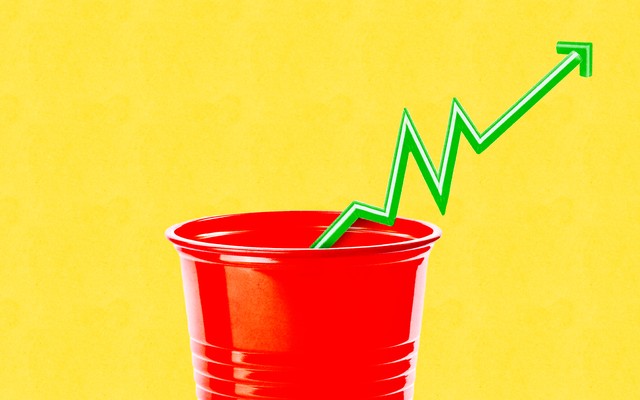 A plastic cup with the straw showing how prices are rising