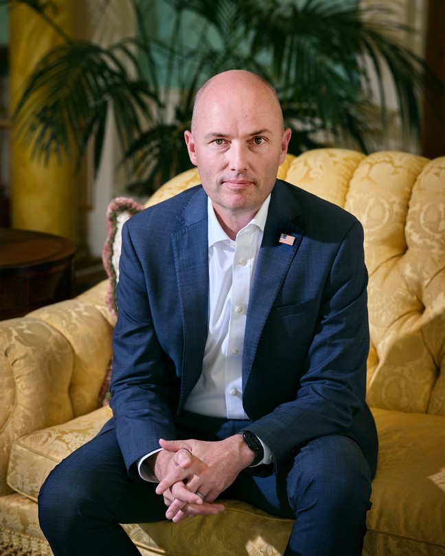 photograph of Spencer Cox in a yellow chair