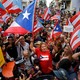 A crowd waving Puerto Rican flags