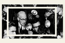 A black-and-white image of paparazzi taking photos