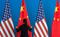 A photo of U.S. and Chinese flags staged for a diplomatic meeting