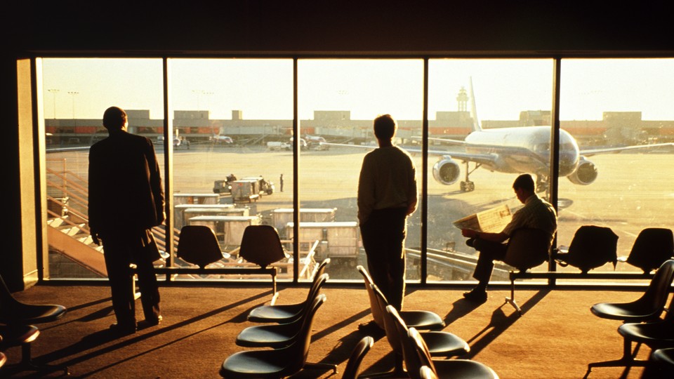 men reading at the airport