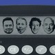 A calculator in front of a blue background with the faces of Elon Musk, Larry Ellison, Mark Zuckerberg, and Jeff Bezos on it’s screen