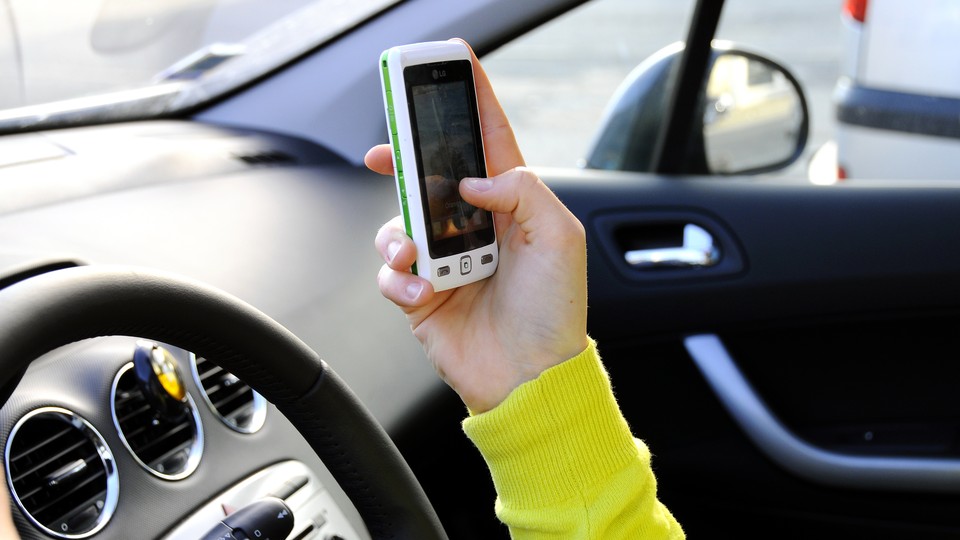 A driver uses a smartphone app in a car
