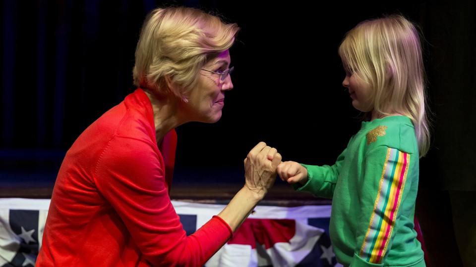 Elizabeth Warren speaking with a young girl