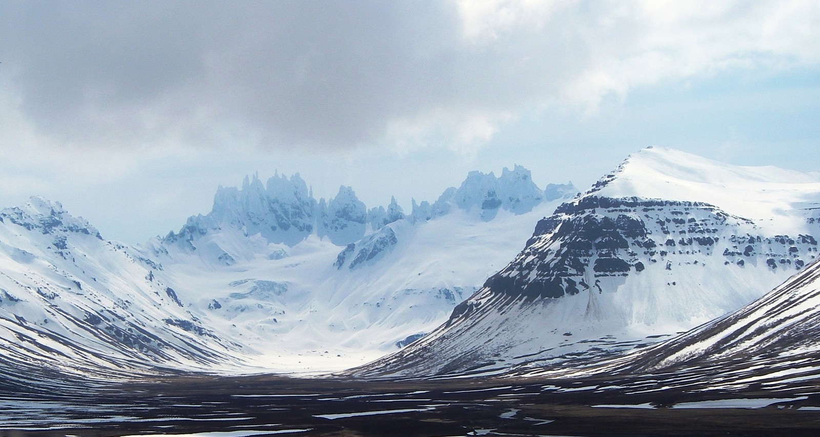 A group of steep snow-covered mountains