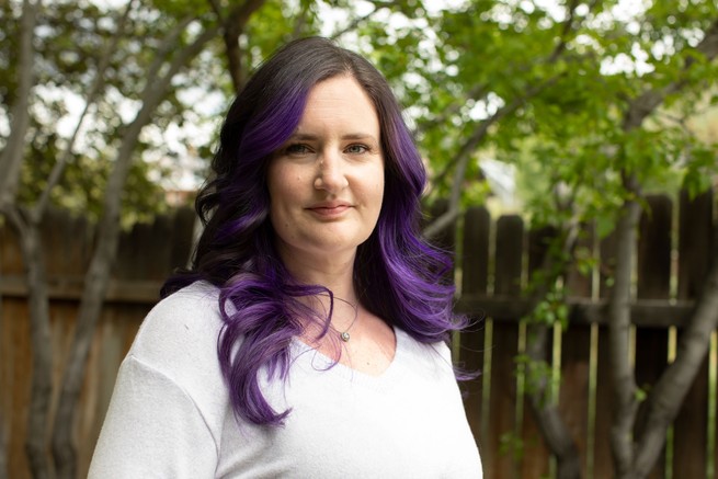portrait of a woman with purple hair outside