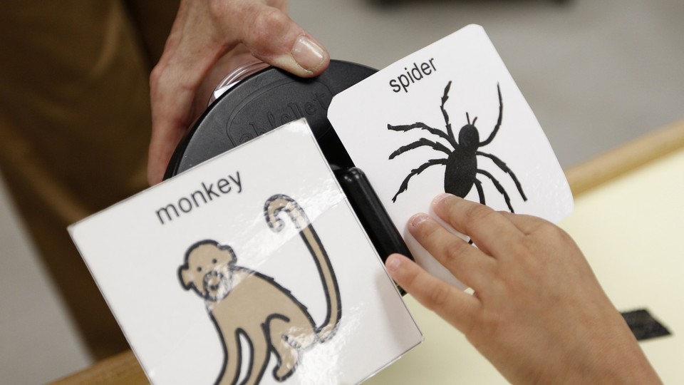 A child's hand hovers over a cartoon of a spider and a monkey.