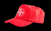 A red baseball cap with the NATO insignia on the front