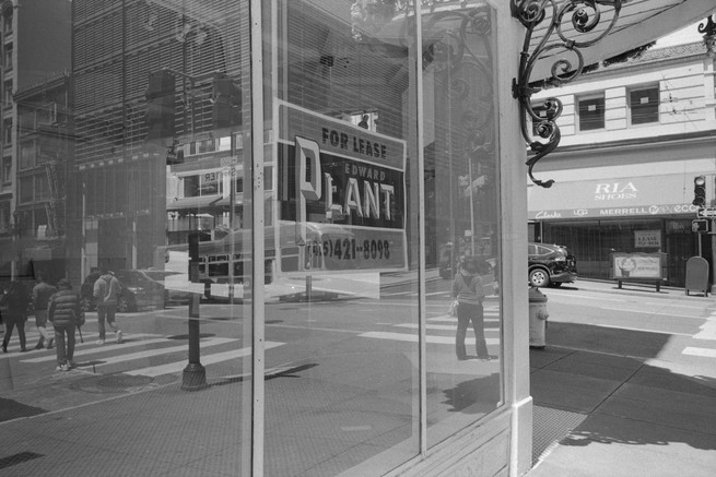 an empty store front with a for lease sign