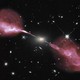 The Very Large Array sees fountains of hot gas erupting from a beastly black hole in the heart of a large galaxy known to radio astronomers as Hercules A. For millions of trillions of miles, these jets shoot through space, finally slowing when they reach ancient gaseous hiccups left behind by this galaxy’s earliest days of star-forming fury.