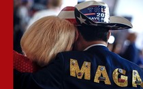 Photo showing woman resting her head on the shoulder of a man wearing "Trump 2024" cowboy hat and a jacket that reads MAGA