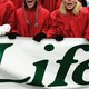 Protesters holding a sign that says "Life"