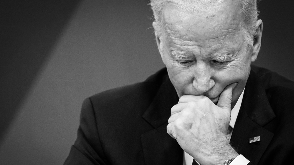 A black-and-white photo of Joe Biden looking pensive